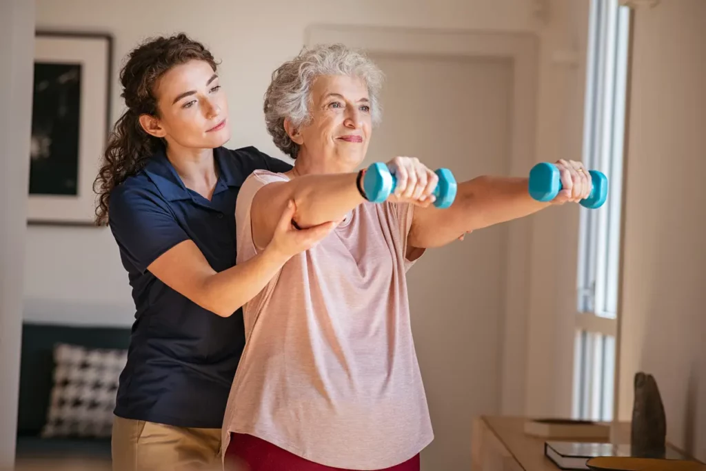 physical therapy aide helping out old lady