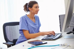 health unit coordinator working on her computer