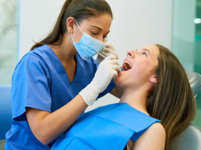 Portrait of a young girl getting a checkup at the dentist