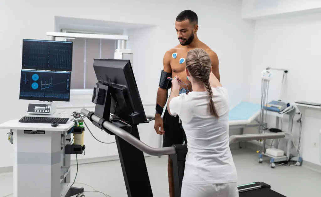 a male getting hooked up to a machine by a technician