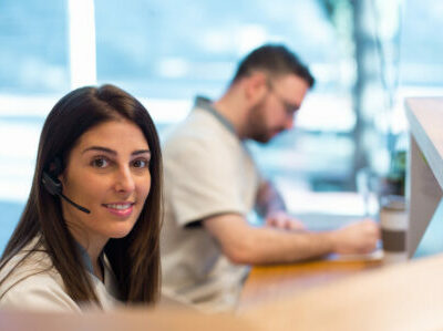 Smiling administrator working with colleague in clinic